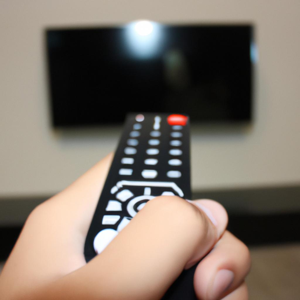 Person holding TV remote control